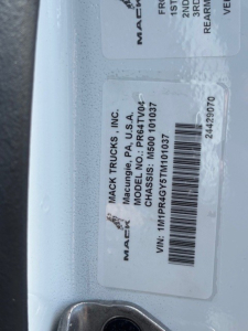 Mack Trucks label on door frame showing MACk Trucks Inc., Model MDS??, VIN 1M5...101037, MACK TRUCKS INC, CHASSIS ID MDS0011037, barcode.