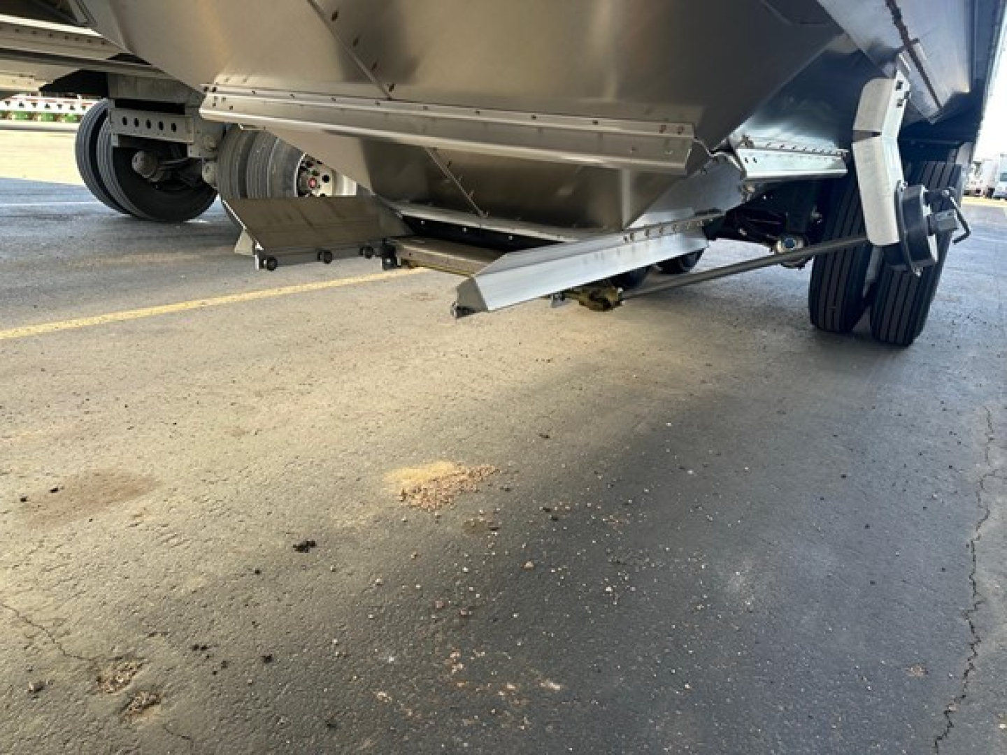 Trailer undercarriage view of a 2026 Timpte Super Hopper showing underside components and landing gear with a focus on the hopper outlet and frame.