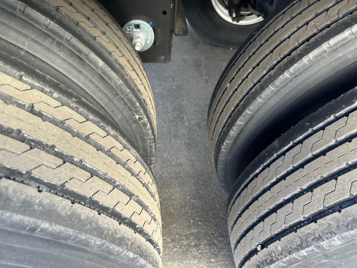 Trailer tires and wheel area of a 2026 Timpte Super Hopper W 66" Sides showing dual tires and undercarriage components.