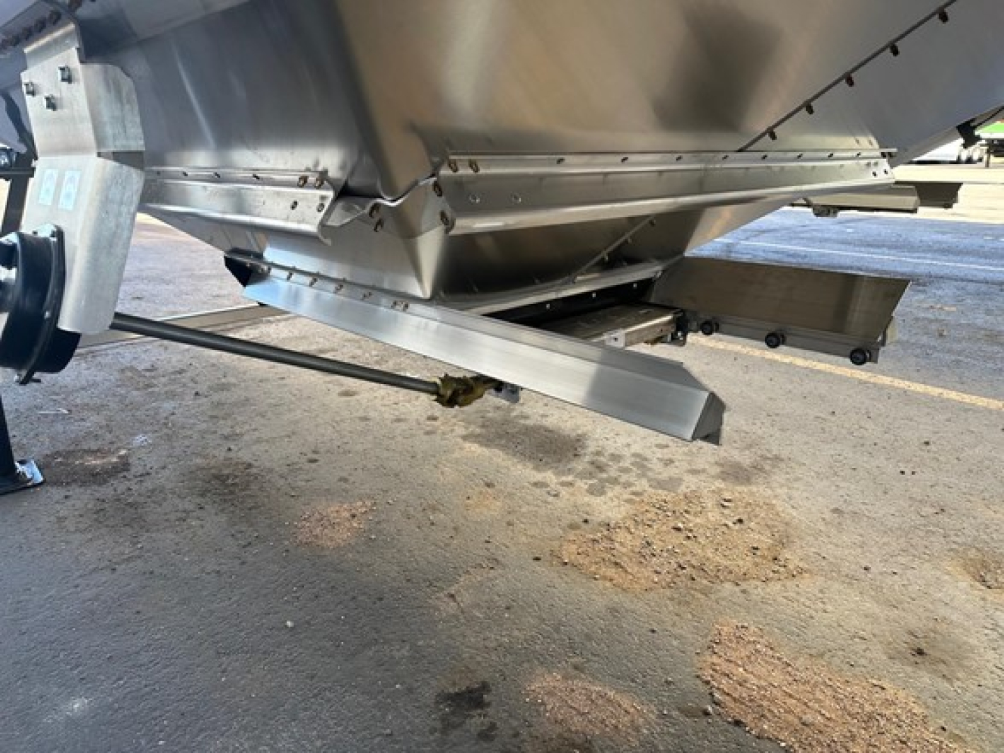 Timbte hopper trailer underside showing steel frame and linkage, aluminum hopper body with support beam and connector bracket.