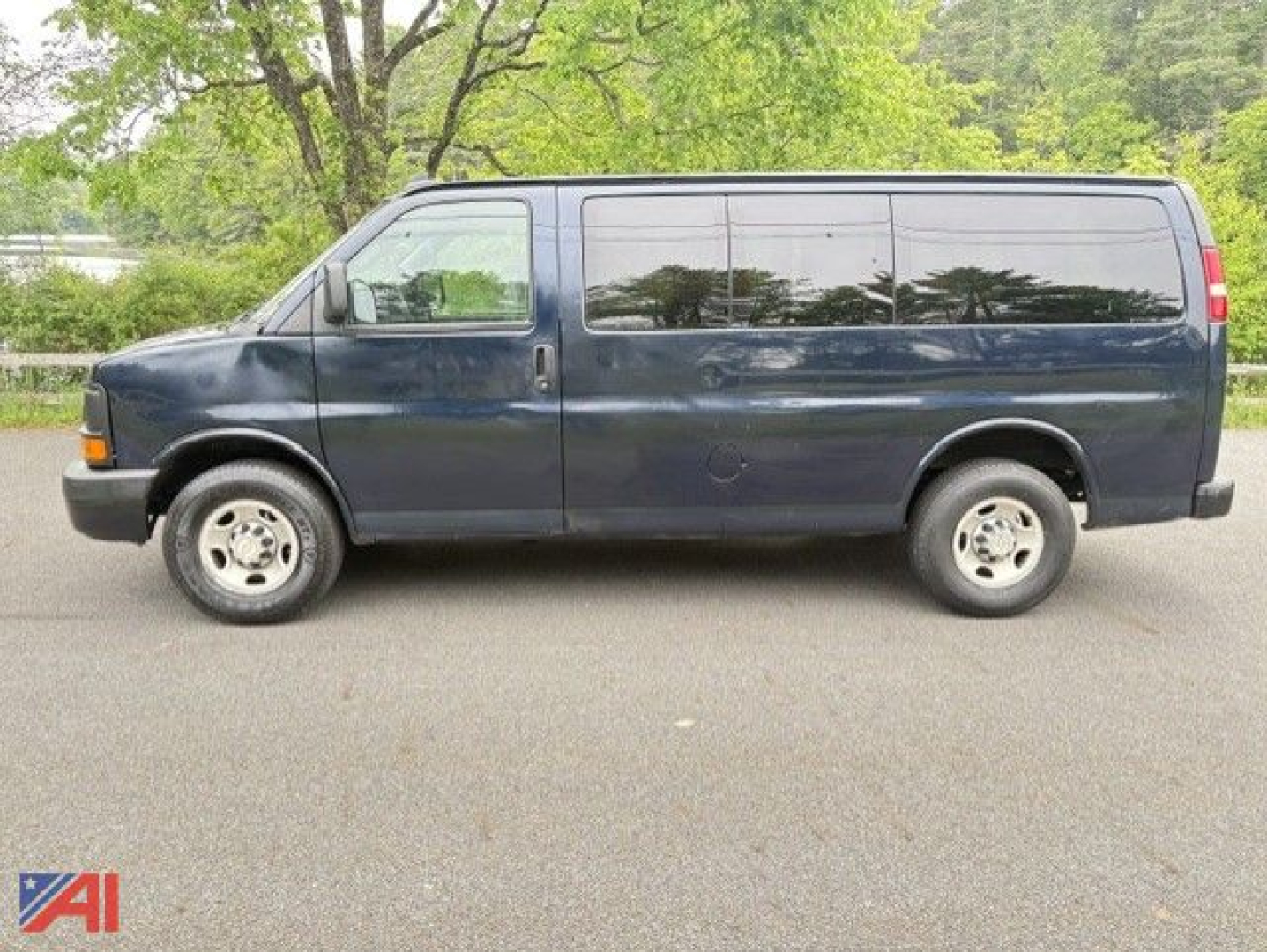 Full-size 2016 Chevrolet Express 2500 van side view showing long wheelbase and dark blue paint.