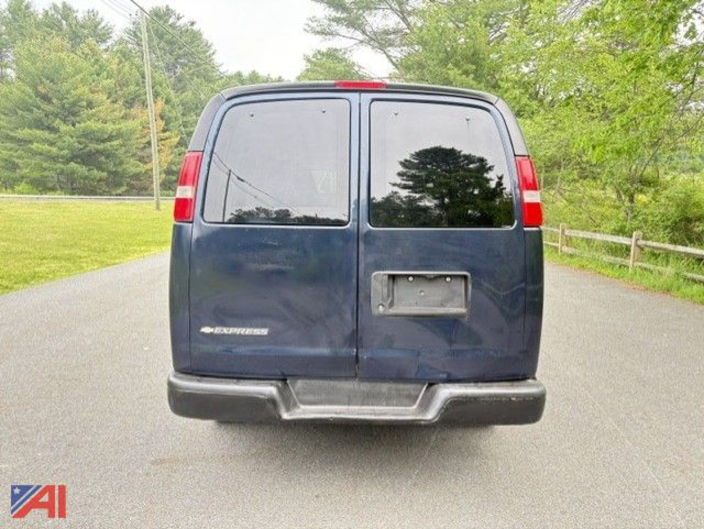 Chevrolet Express 2500 van rear view showing dual rear doors with small window glass, rear bumper, and tail lights.