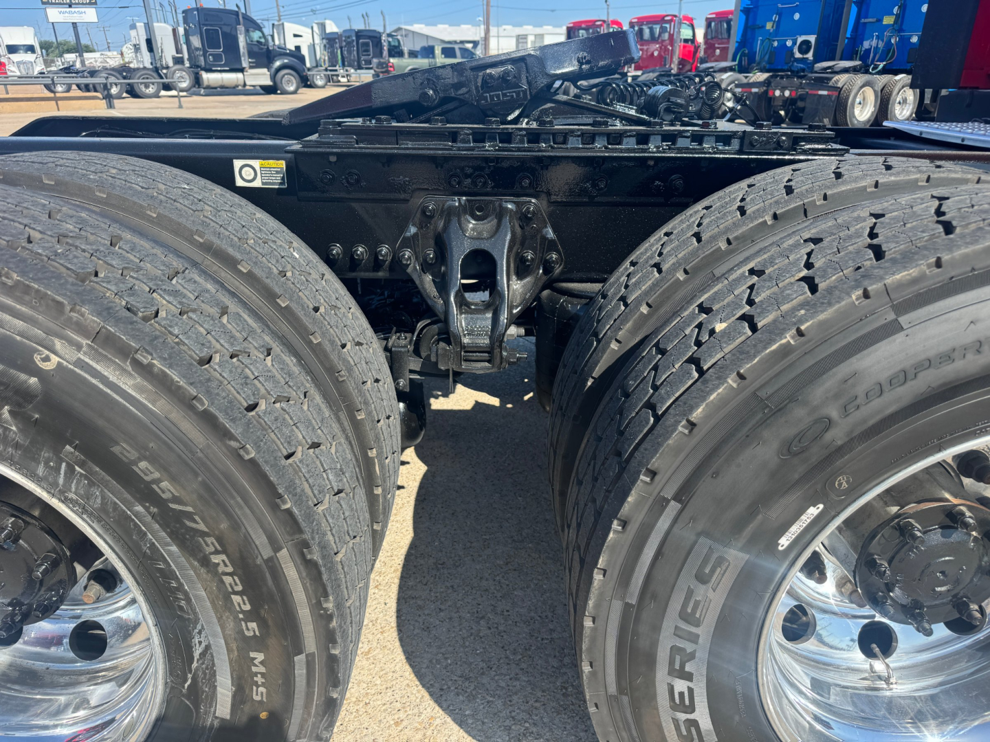 Kenworth T680 rear view showing tandem axle and dual tires with chrome wheels and fifth wheel area visible
