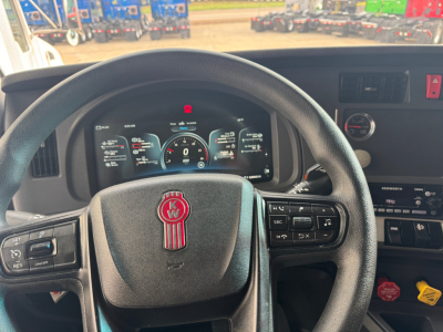 Kenworth T680 interior steering wheel and dashboard showing digital instrument cluster and control buttons