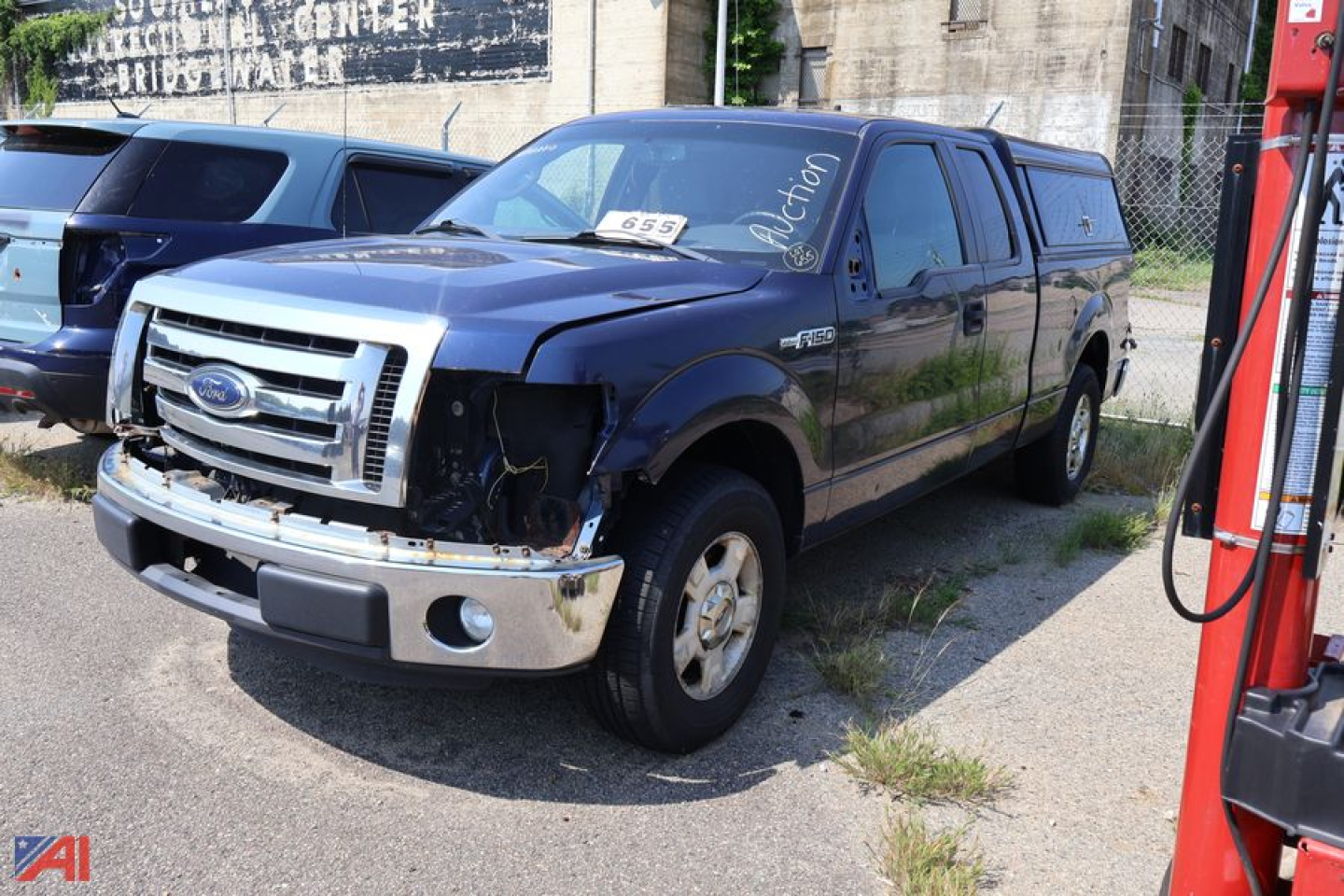 Ford F-150 pickup truck in-service with front-end damage; blue exterior, chrome bumper, cap-shaped bed cap, 2-door crew cab style shown, damaged left headlight area