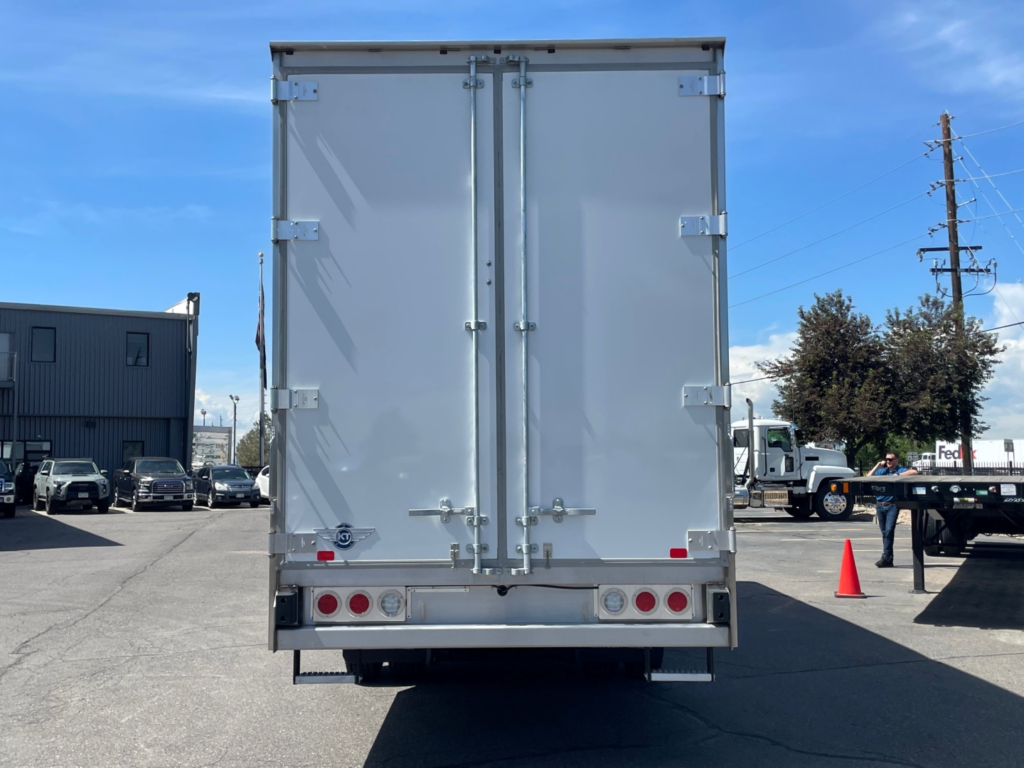 Mack MD6 box truck rear showing double doors and taillights.