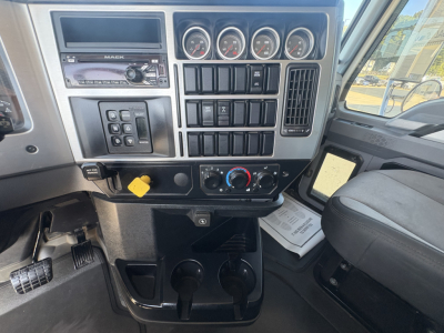 Dashboard of a 2021 Mack GR64F truck showing instrument cluster, control switches, and climate controls in center console.