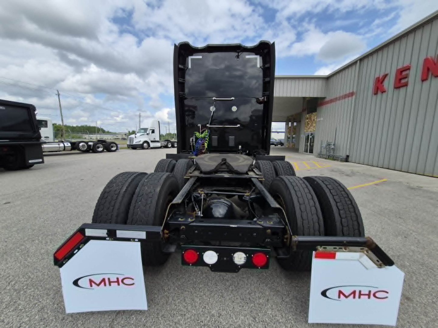 Kenworth T680 tractor rear view showing dual rear axles and sleeper semi-truck chassis, stock number 0625560.