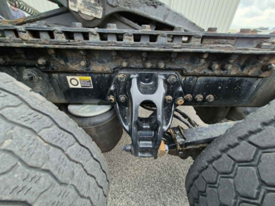 Kenworth T680 chassis rear view showing fifth wheel hitch and dual rear tires with undercarriage and frame components.