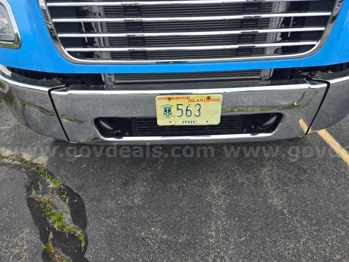 Front view of a 2019 Freightliner M2 truck showing chrome bumper, grille, and Rhode Island license plate 563.