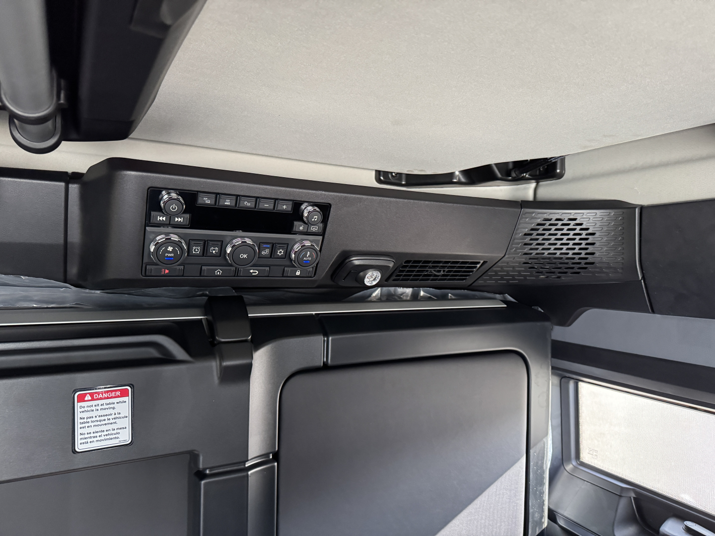 Truck cab interior showing control panel and HVAC vents in Mack PR64T76H sleeper cab.