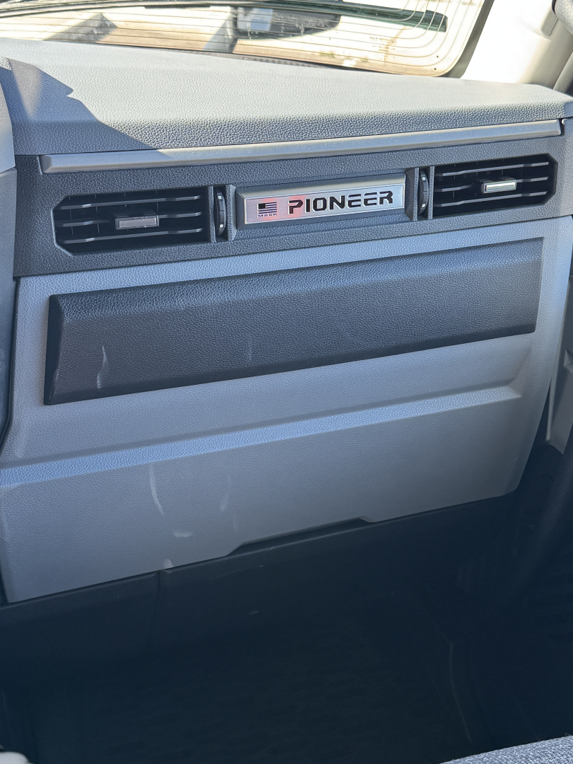 Dashboard area of a Mack truck cab showing Pioneer air vent panel and glove box.