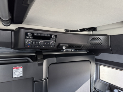 Truck cab interior showing control panel and HVAC vents in Mack PR64T76H sleeper cab.