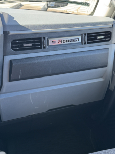 Dashboard area of a Mack truck cab showing Pioneer air vent panel and glove box.