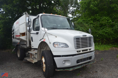 Front three-quarter view of a 2017 Freightliner M2 106 Sweeper truck showing white cab, side exhaust, and sweeper body.