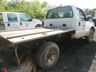 2006 Ford F-350 Super Duty cab with flatbed, single rear wheel, side view shows extended flatbed and rear wheel area.