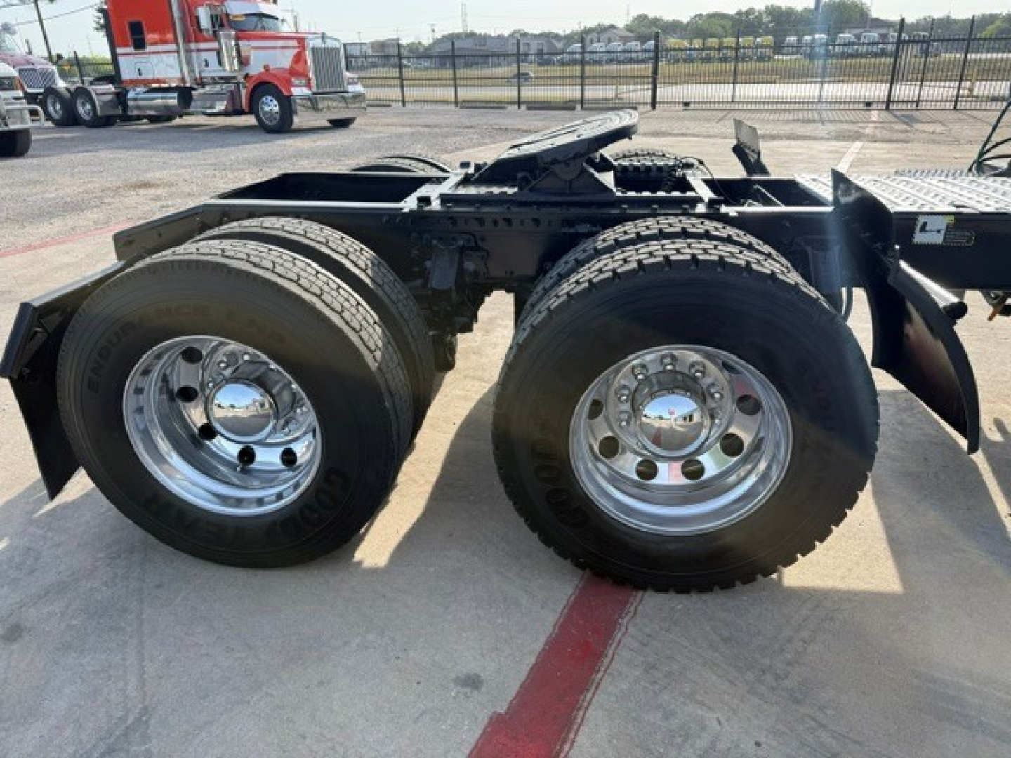 Mack ANTHEM truck chassis showing dual rear axles with large tires and chrome rims.