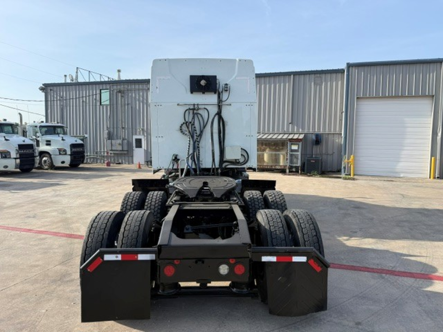 Truck cab and chassis rear view of a 2020 Mack ANTHEM tractor showing dual rear axles and fifth-wheel area.