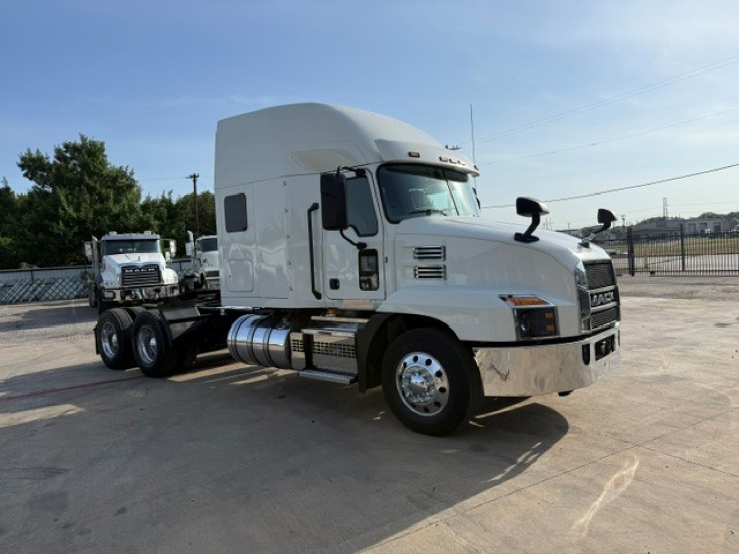 Mack ANTHEM truck tractor in white, side view showing cab sleeper, fuel tanks, and dual rear axles.