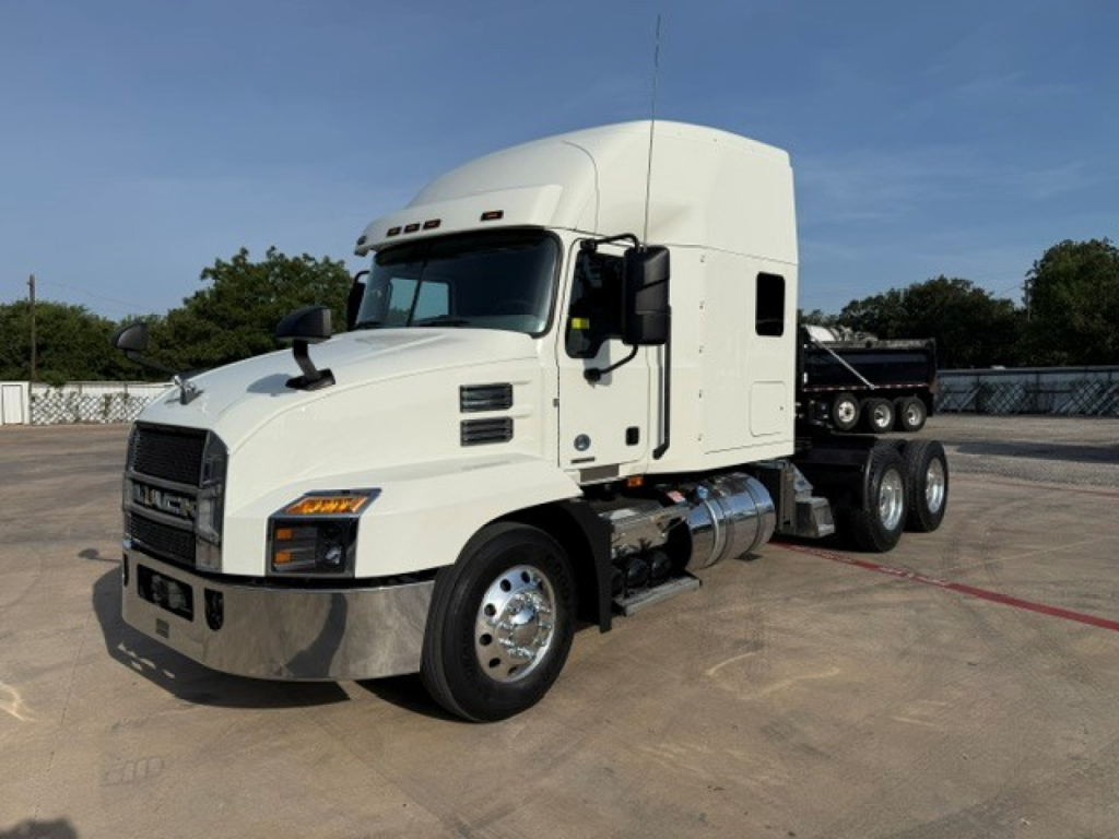 White 2020 Mack Anthem conventional sleeper truck in a parking lot, side view showing fuel tanks, dual rear axles, and large cab.
