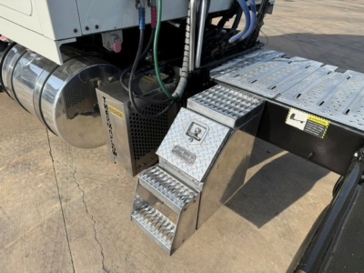 Truck step area on a 2020 Mack ANTHEM showing diamond-plate metal steps and fuel tank in a sleeper cab configuration.