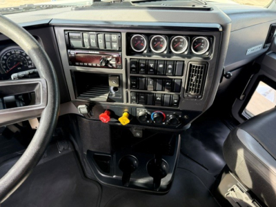 Dashboard and steering wheel of a 2020 Mack Anthem truck interior showing instrument cluster,control panels, switches, and knobs.