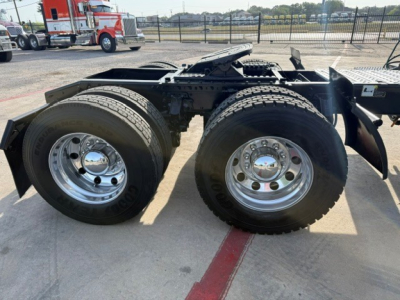 Mack ANTHEM truck chassis showing dual rear axles with large tires and chrome rims.