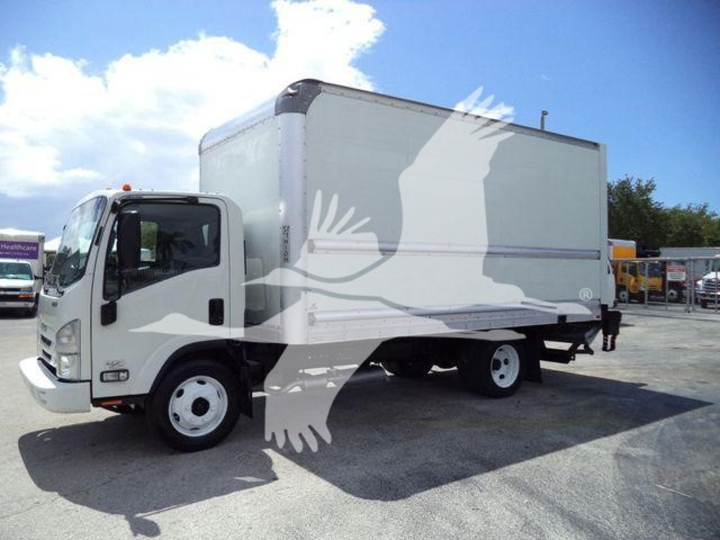 Isuzu NPR-HD box truck in service showing cargo box and cab exterior.