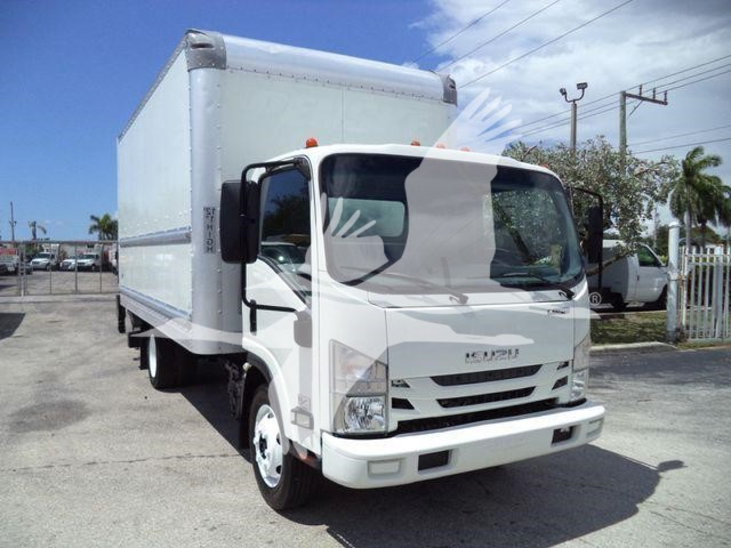 Isuzu NPR HD box truck front-left view with cargo box in white.