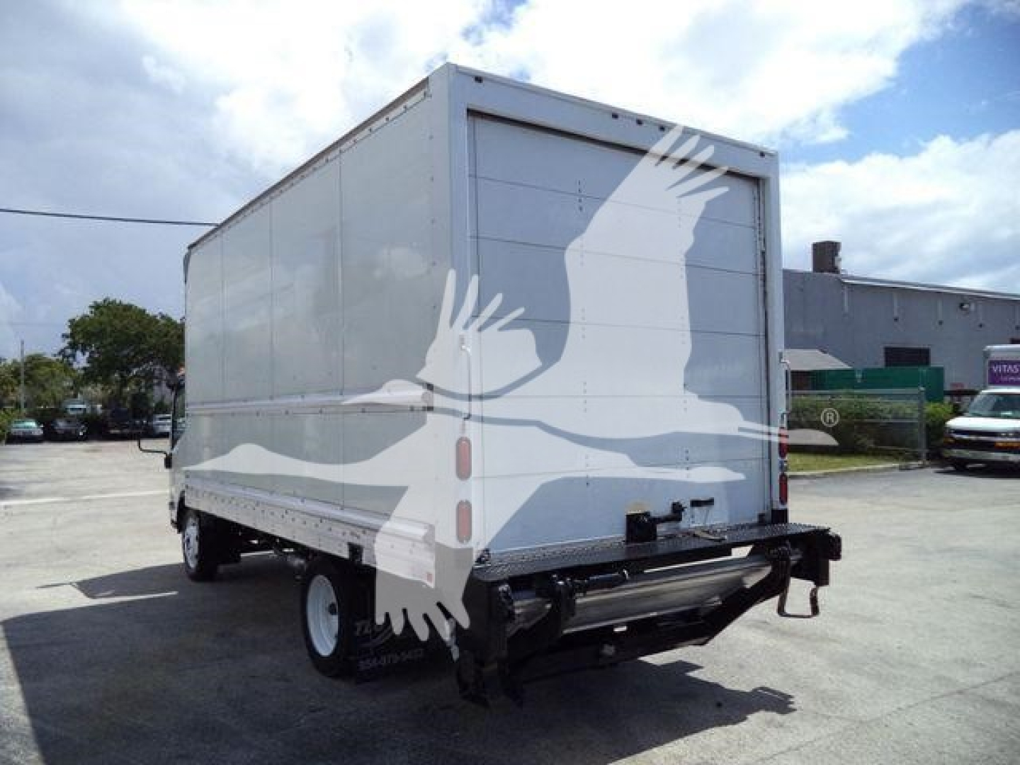 Isuzu NPR HD box truck rear view showing rear doors and bumper.