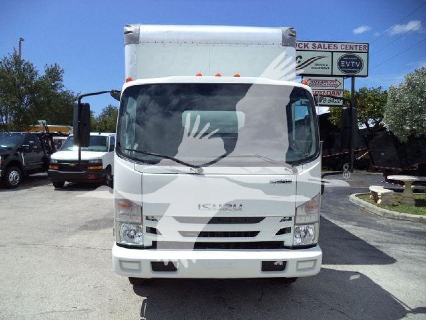 Isuzu NPR-HD box truck front view showing windshield, grille, bumper, and Isuzu emblem.