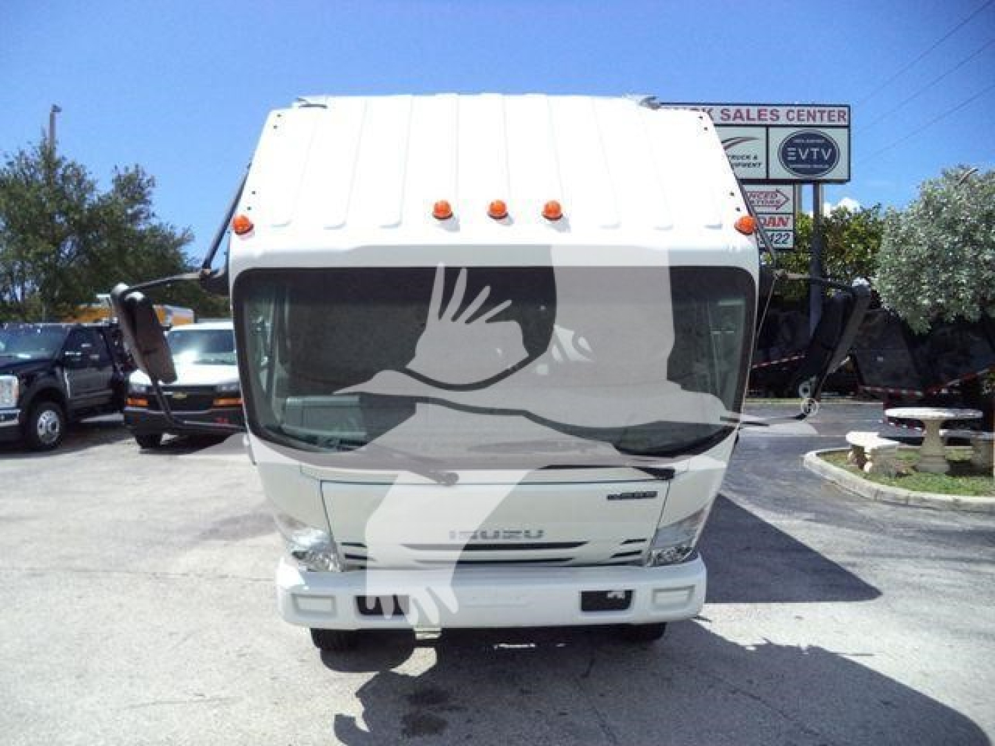 Isuzu NPR-HD cab front view showing windshield, grille, and headlights.