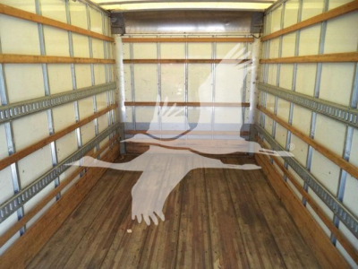 Isuzu NPR-HD box truck interior showing empty cargo area with wooden floor and metal side rails.