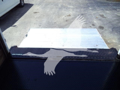 Truck bed area of 2016 Isuzu NPR HD with ramp/step and metal surface visible.