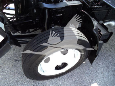Isuzu NPR-HD truck wheel and front suspension components visible in the engine bay area.