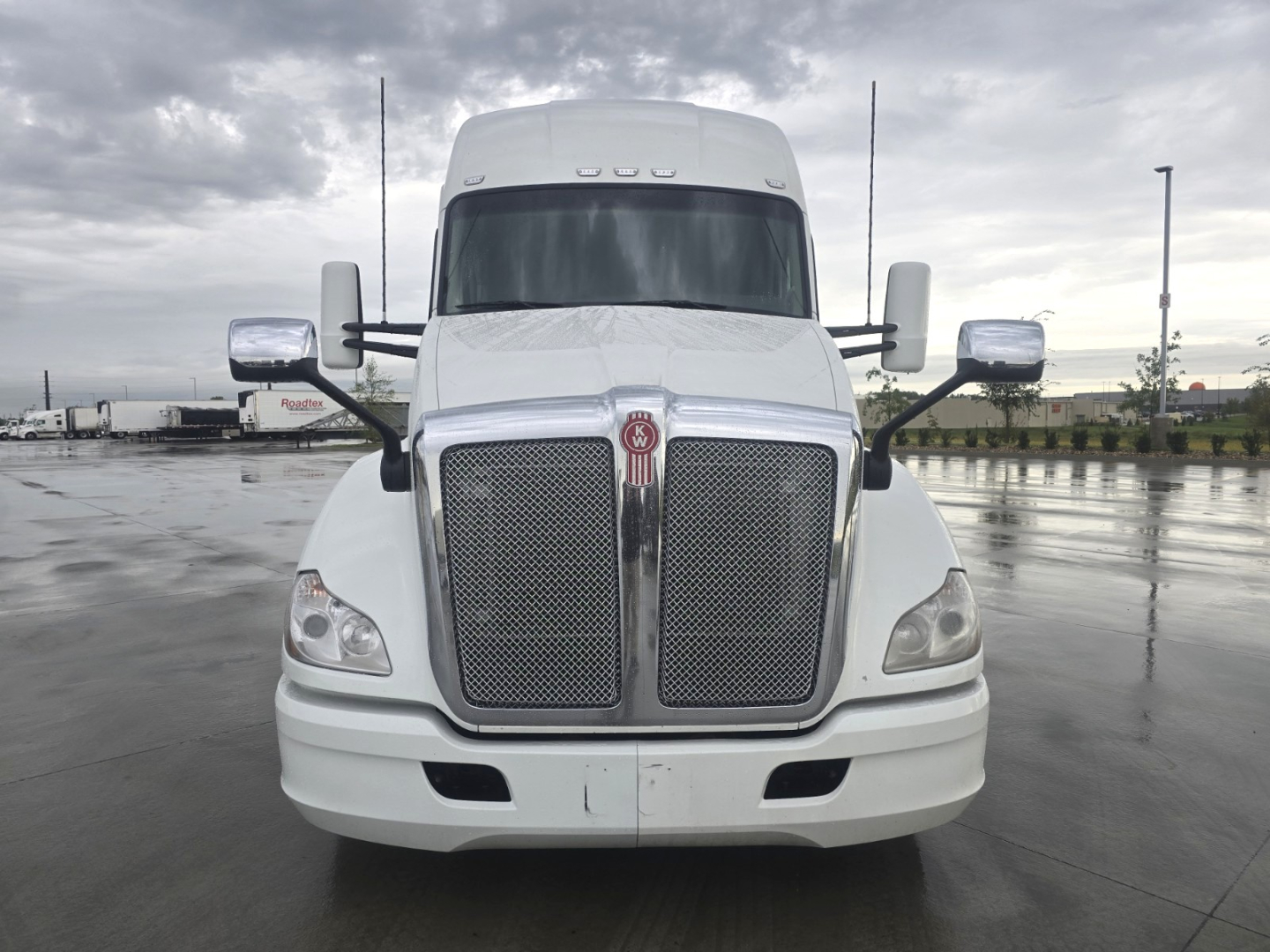 Kenworth T680 2021 conventional sleeper front view showing large chrome grille and dual mirrors.