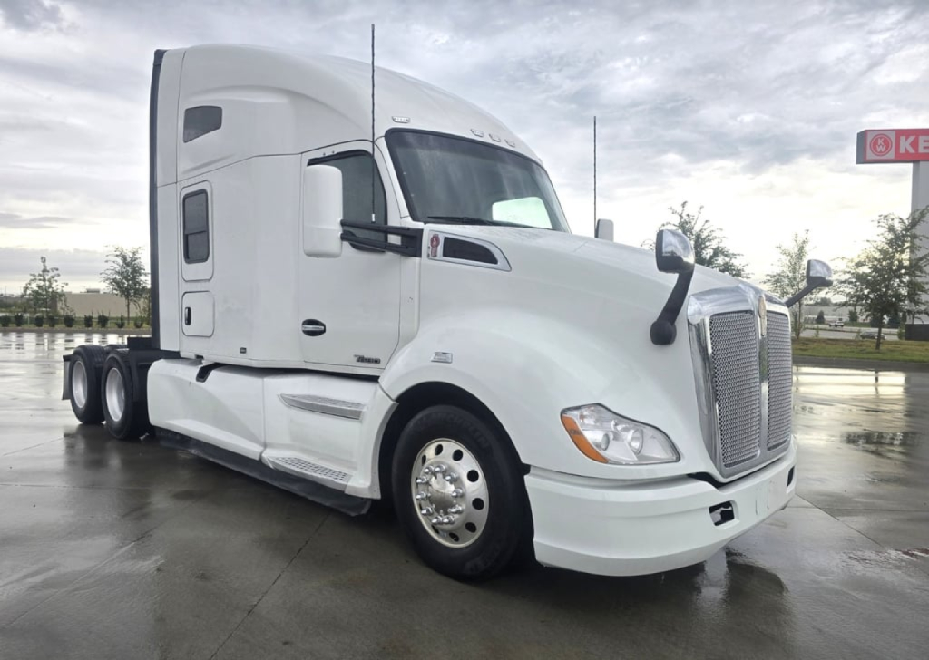Kenworth T680 conventional sleeper tractor in white, front left view, with Kenworth emblem and side mirrors.
