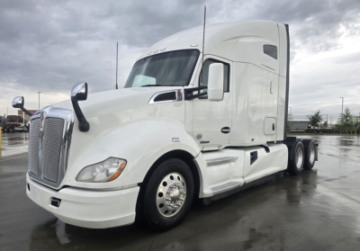 Kenworth T680 2021 conventional sleeper truck in white, front three-quarter view with chrome grille, large bumper, and dual rear axles.
