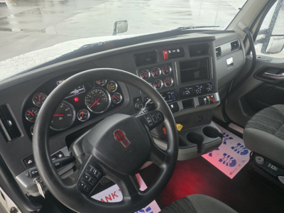 Kenworth T680 interior steering wheel and dashboard showing gauges and controls in cab view.
