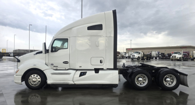 Kenworth T680 tractor side view showing sleeper cab and rear axles.