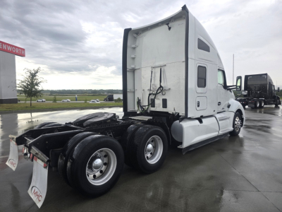 Kenworth T680 truck tractor with sleeper cab in view showing side and rear with wheels, hitch area, and fuel tanks.