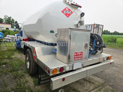 Tank trailer rear showing cylindrical tank, hazard placard 1075, rear toolbox, and bumper with lights.
