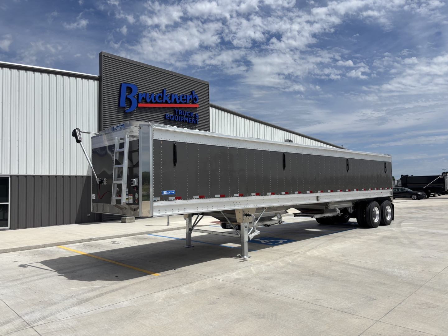 Trailer hitch with 40' aluminum grain hopper trailer on gooseneck, 68 inch side walls, dual rear axles, parked outside at Bruckners truck equipment.