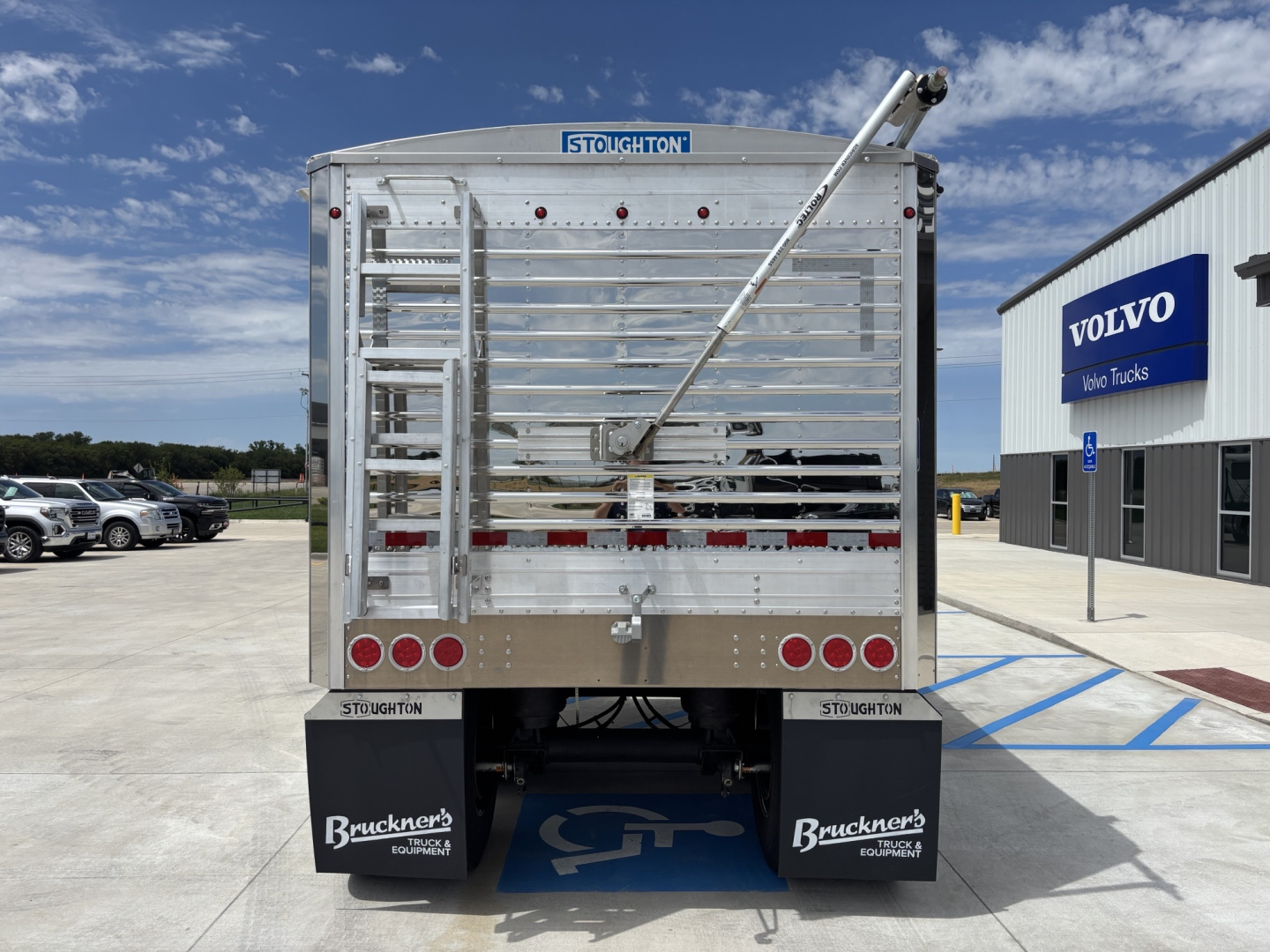 Rear view of a new 2027 Stoughton 40' aluminum grain hopper trailer with 68" sides, VIN 1DW1G4022VSC24498, stock 73342, showing rear gates, ladders, and mud flaps.