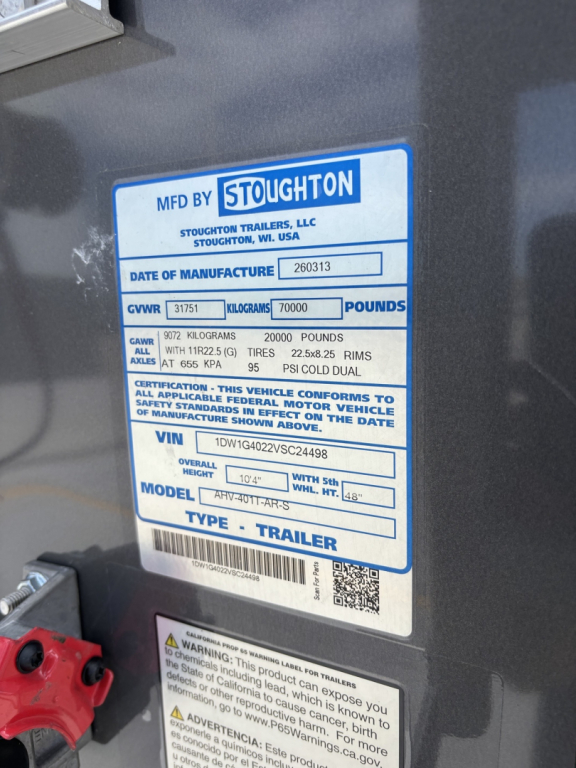 Trailer identification label showing MFD BY SToughton Trailers, date of manufacture, GVWR 70000 lbs, GAWR 20000 lbs, axle rating 1225 kg? (visible). VIN 1DW1G4022VSC24498 on a Stoughton trailer service label.
