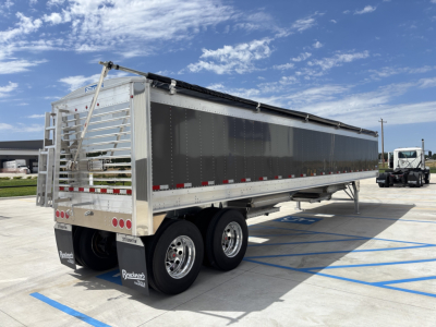 Stoughton 40' aluminum grain hopper trailer with 68" sides, silver exterior, dual rear axles, and tarp system in a parking lot.
