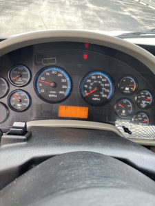 Dashboard of a 2018 International 4300 truck showing multiple gauges including RPM, MPH, and warning lights; orange P indicator visible.