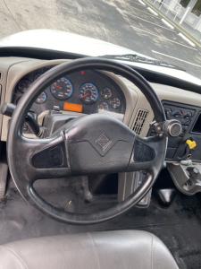Interior view of a 2018 International 4300 cab showing steering wheel and instrument cluster with gauges and controls.