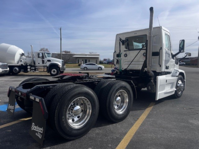 Mack PR64T tractor-trailer cab shown from rear-left side with dual rear axles and white cab, no trailer attached.