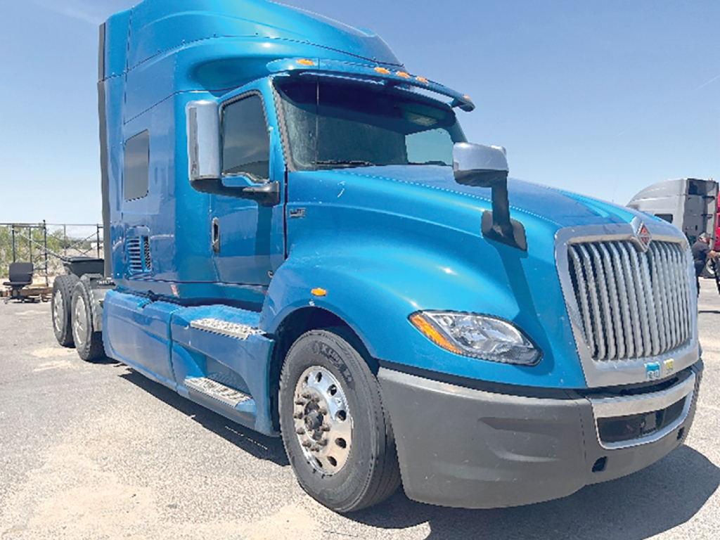 Blue 2020 International LT625 truck cab in profile view showing sleeper cab and chrome grille.